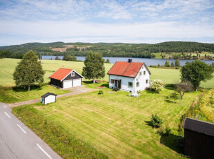 Minibruk med trivelig hus og dobbeltgarasje på idyllisk tomt med flott utsikt til Nugguren - 6,8 daa fulldyrket jord