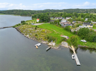 Sjønær og landlig enebolig med praktfull utsikt og solrike uteplasser. Dobbelgarasje, sommerstue og bøyeplass for båt.