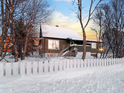 Enebolig over tre plan, tre soverom, hageområde, veranda, parkering i garasje og biloppstillingsplass på eiendommen.