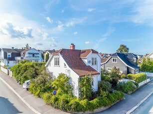 Sjarmerende enebolig med en meget sentral beliggenhet og en usjenert idyllisk hagetomt